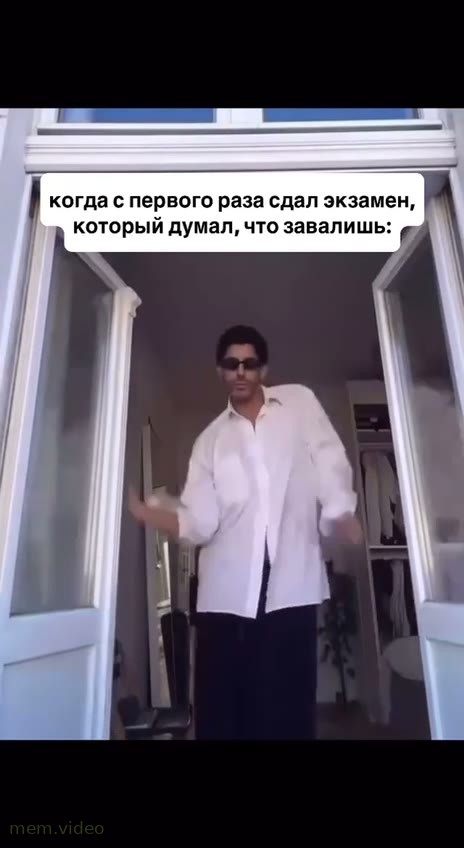 Кадр: Мужчина в белой рубашке и очках танцует у окна
